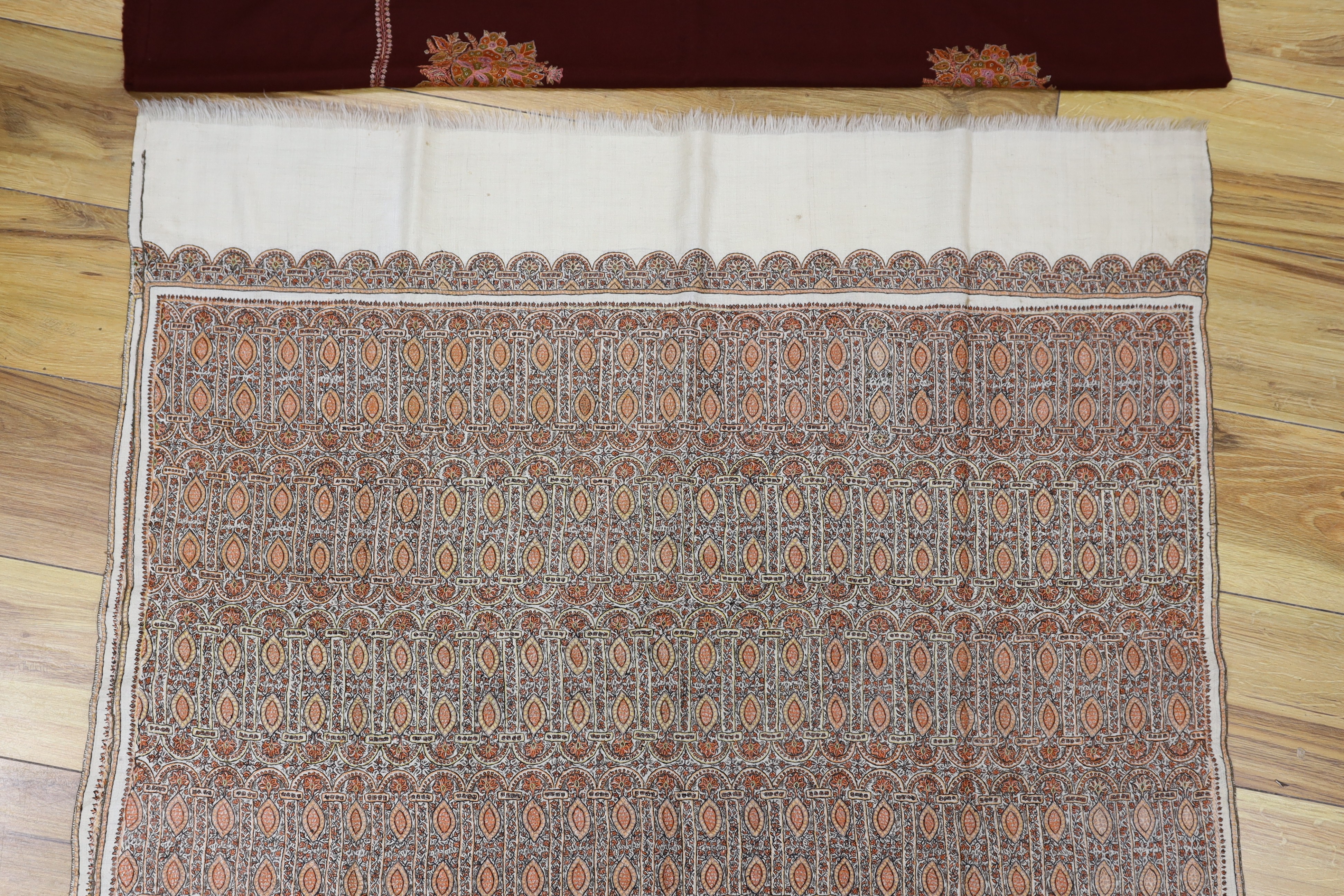 An Indian 20th century pashmina silk embroidered shawl and a cashmere wool shawl with spot motif embroidery